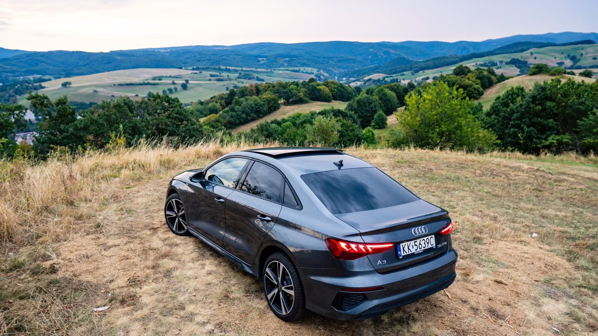 Audi A3 parked on a hillside with breathtaking view of Slovakian landscape.